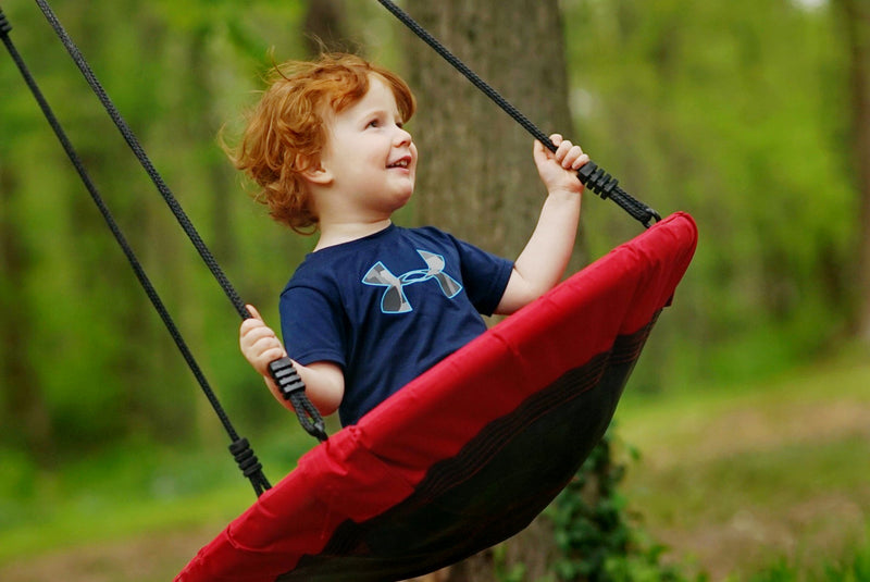child on rope swing swinging 