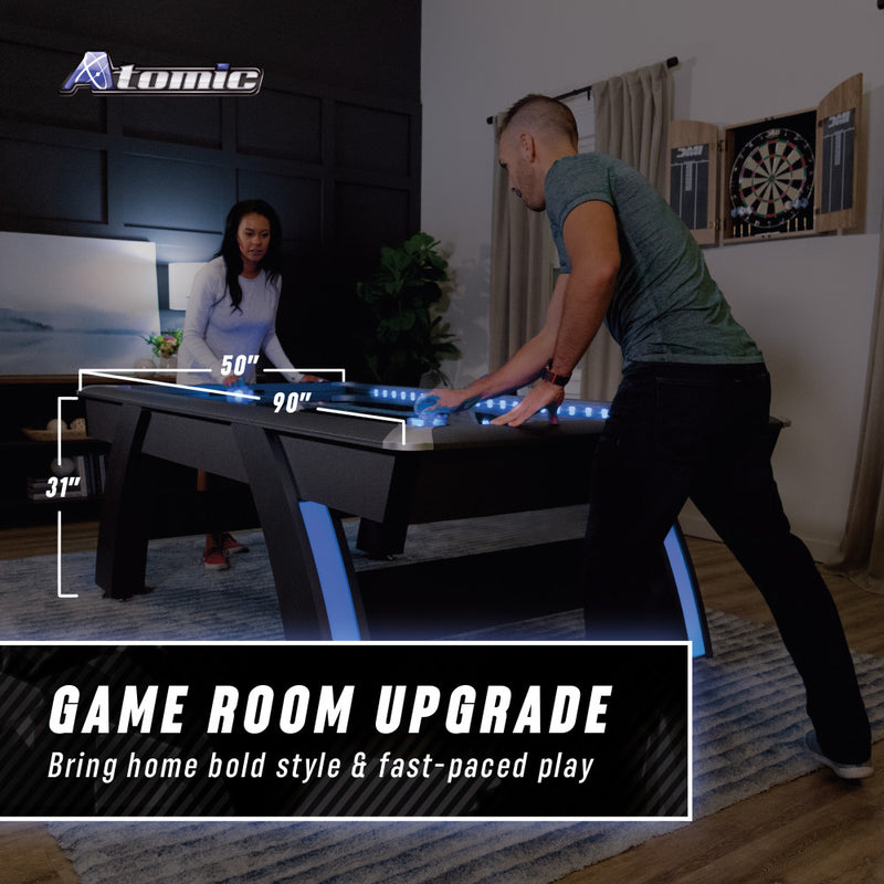overhead drop lighting and black lights on air hockey table tournament setup